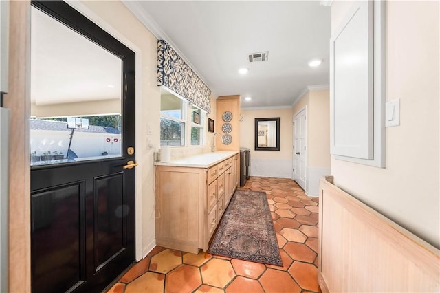 interior space featuring ornamental molding and tile patterned floors