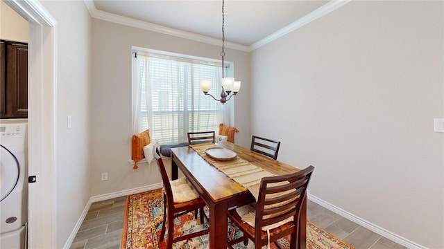 dining room with wood-type flooring, washer / clothes dryer, an inviting chandelier, and ornamental molding