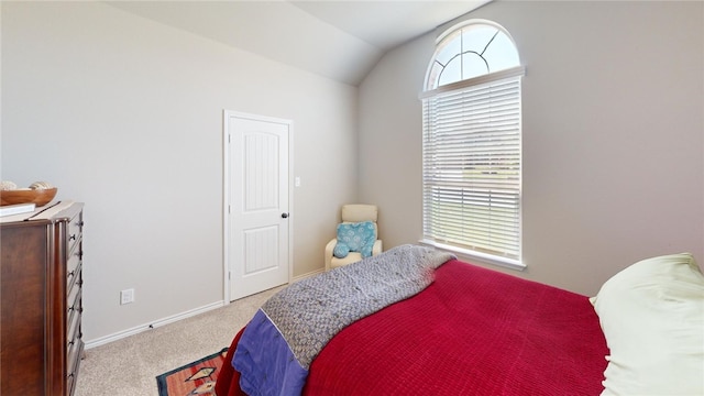 bedroom featuring light carpet and lofted ceiling