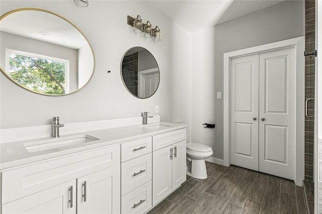 bathroom featuring walk in shower, toilet, vanity, and hardwood / wood-style flooring