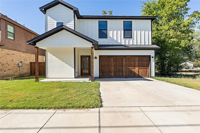 modern farmhouse featuring a front yard and a garage