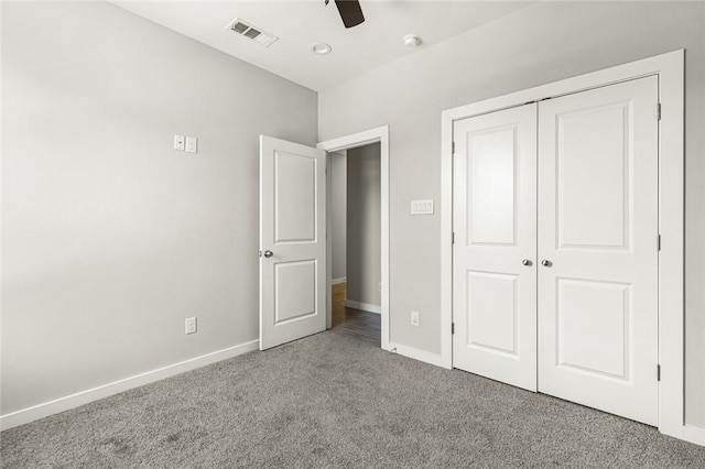 unfurnished bedroom featuring carpet floors, a closet, and ceiling fan