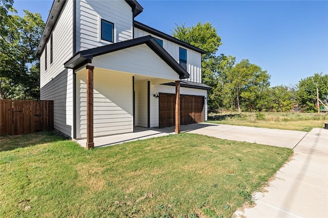 view of property exterior featuring a yard and a garage