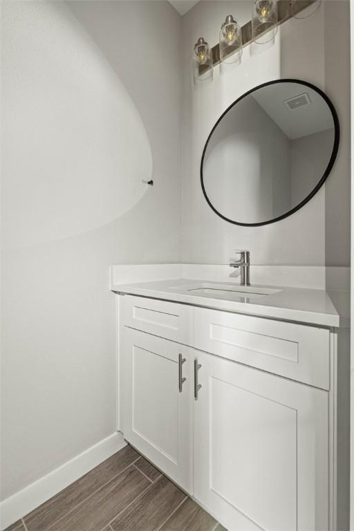 bathroom with hardwood / wood-style floors and vanity