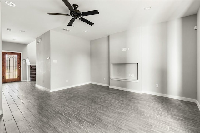 unfurnished living room with ceiling fan and wood-type flooring