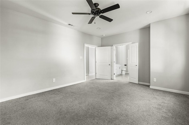 unfurnished bedroom with ensuite bath, ceiling fan, and carpet floors