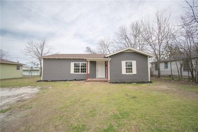 view of front of property with a front yard and fence