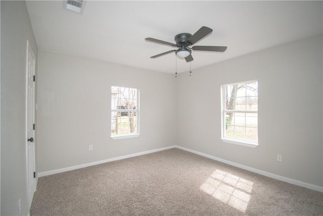 unfurnished room with a ceiling fan, baseboards, visible vents, and carpet flooring