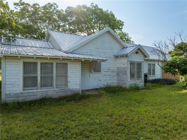 view of side of home with a yard