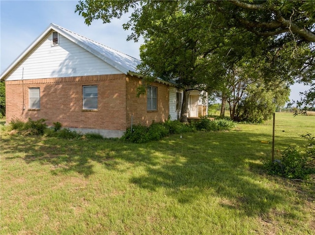 view of side of home featuring a yard