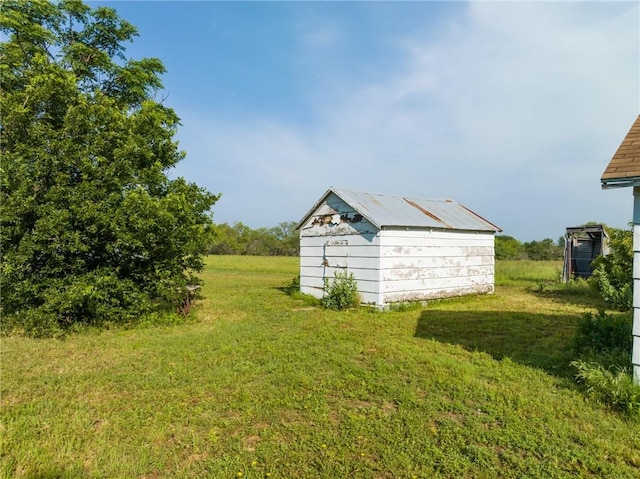 view of outbuilding featuring a lawn