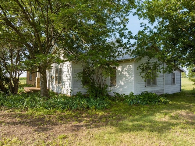 view of home's exterior with a yard