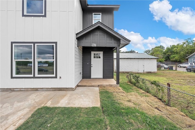 doorway to property with a lawn