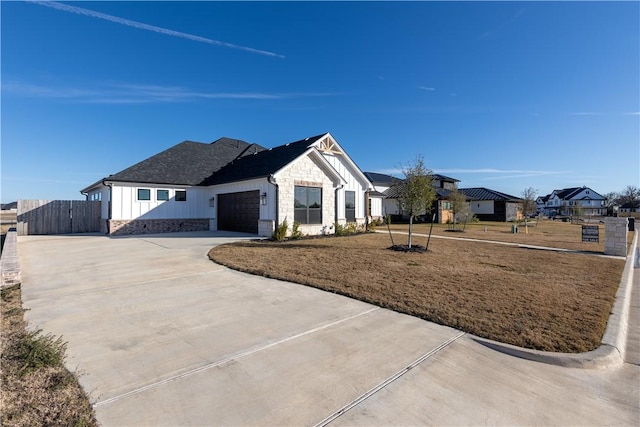 modern farmhouse style home with a front yard and a garage