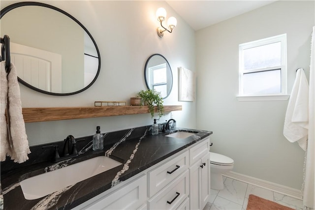 bathroom featuring toilet and vanity