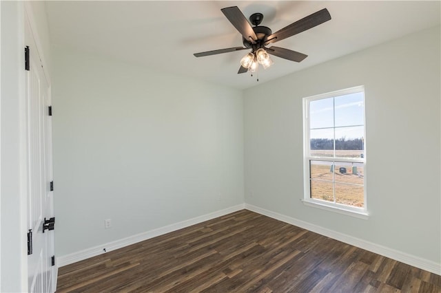 empty room with ceiling fan and dark hardwood / wood-style flooring