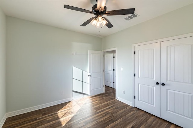 unfurnished bedroom with ceiling fan, a closet, and dark hardwood / wood-style flooring