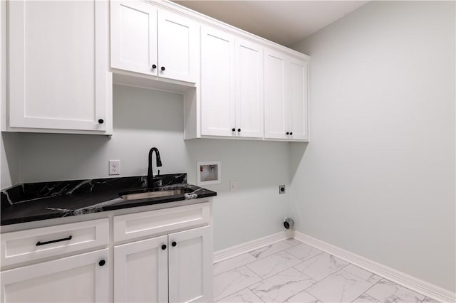 laundry room with electric dryer hookup, sink, hookup for a washing machine, and cabinets