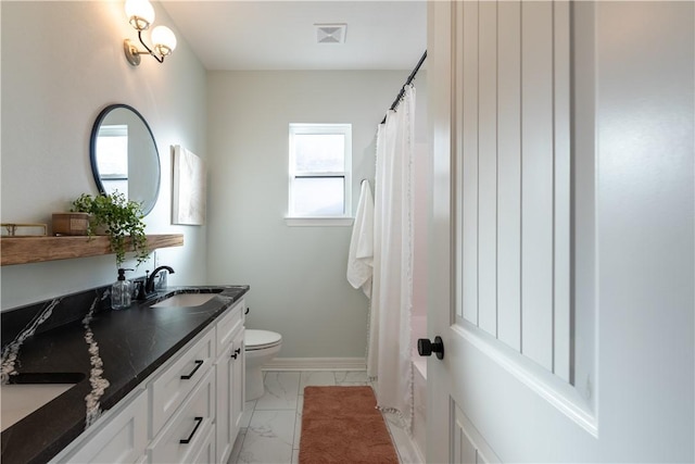 bathroom featuring toilet and vanity