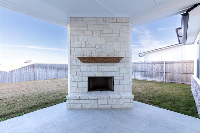 view of patio / terrace featuring an outdoor stone fireplace