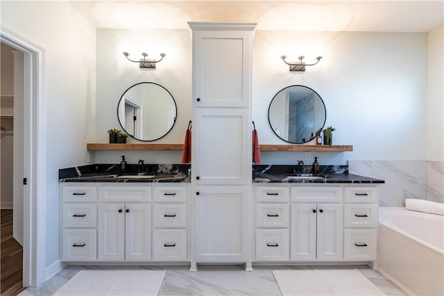 bathroom with vanity and a bath