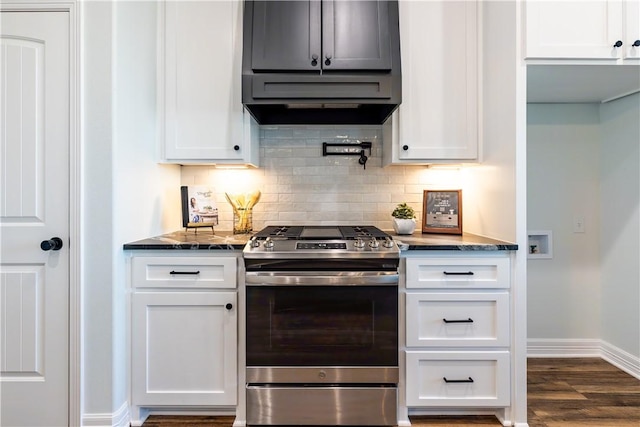 kitchen featuring dark hardwood / wood-style flooring, dark stone countertops, gas stove, and white cabinets