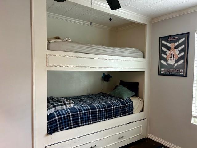 bedroom featuring ceiling fan and ornamental molding