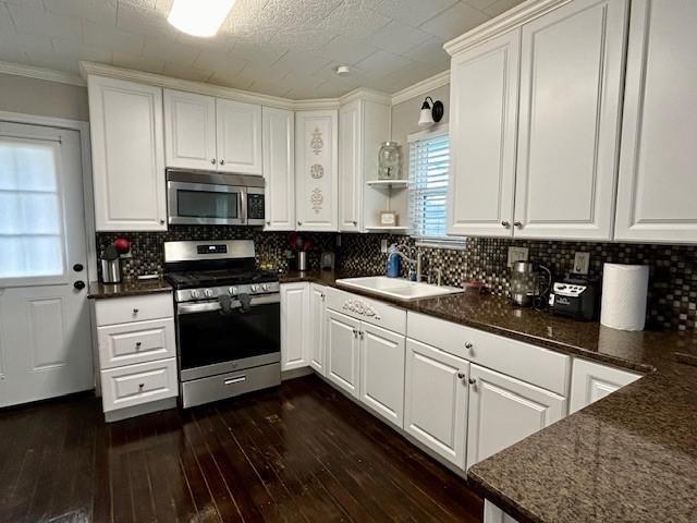 kitchen featuring white cabinets, plenty of natural light, dark hardwood / wood-style floors, and stainless steel appliances