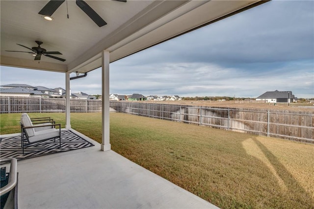 view of yard with ceiling fan and a patio area