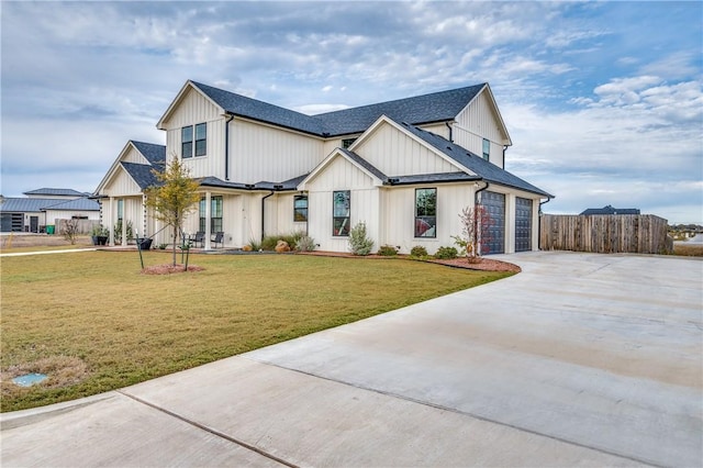 modern farmhouse with a garage and a front lawn