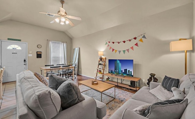 living area with ceiling fan, visible vents, and vaulted ceiling