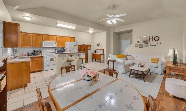 dining space featuring ceiling fan and light tile patterned floors