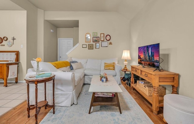 living area with light wood-type flooring and baseboards