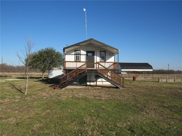 rear view of house with a carport and a yard