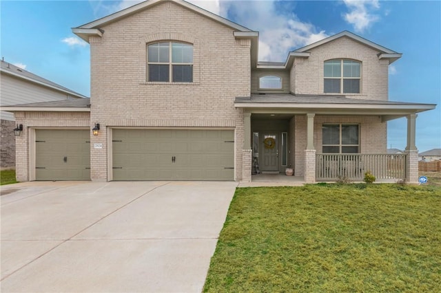 view of front of home featuring a garage, covered porch, and a front yard