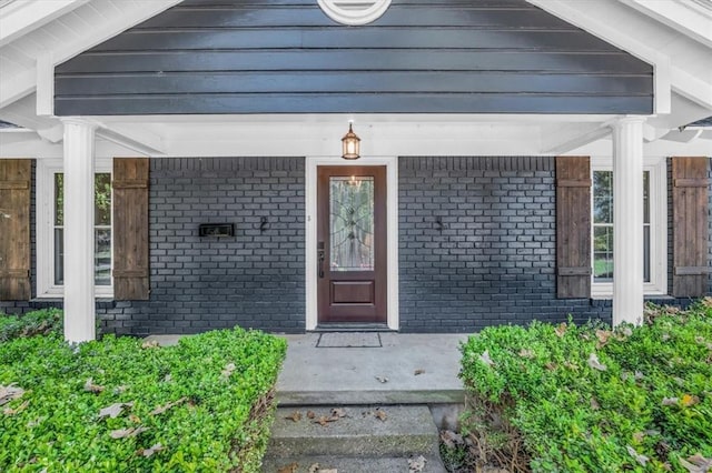 view of exterior entry with covered porch