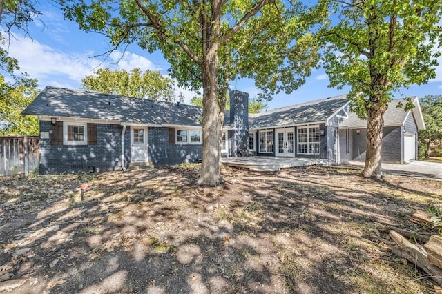 single story home featuring french doors and a garage