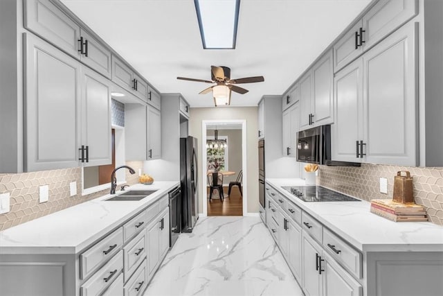 kitchen featuring gray cabinetry, ceiling fan, sink, and stainless steel appliances