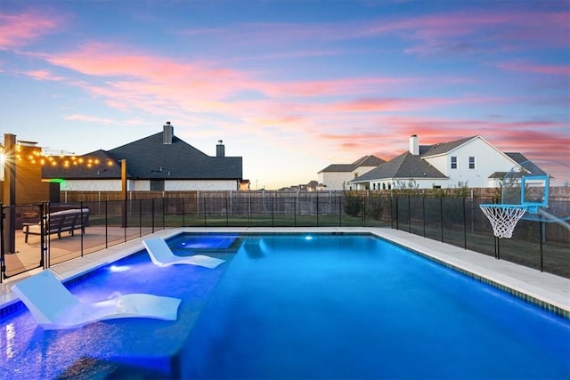 view of pool at dusk