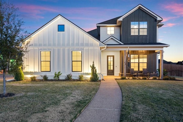 modern farmhouse style home with a lawn