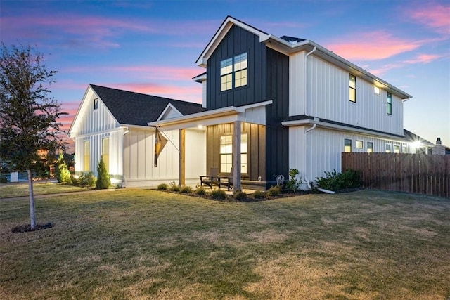 back house at dusk with a yard