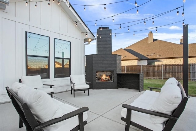 view of patio with an outdoor living space with a fireplace