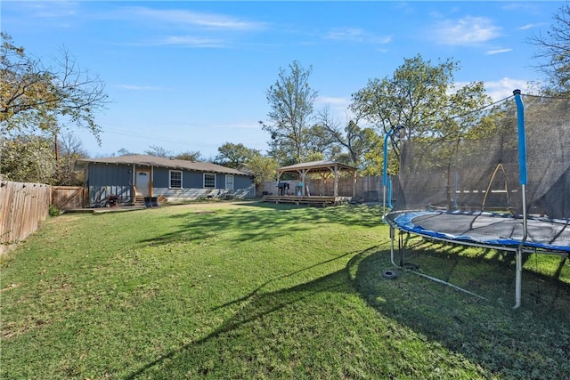 view of yard featuring a gazebo and a trampoline