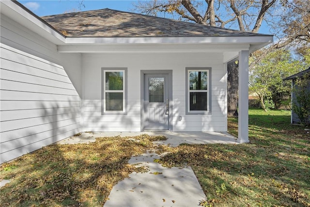 entrance to property featuring a lawn