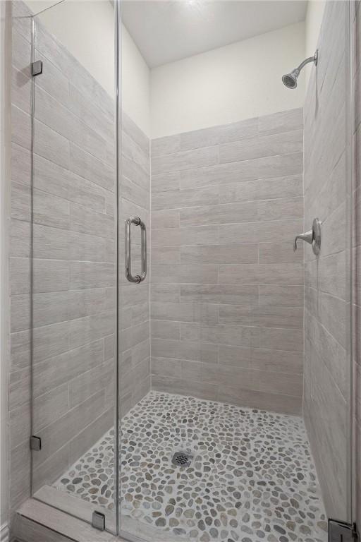 bathroom with a shower with door