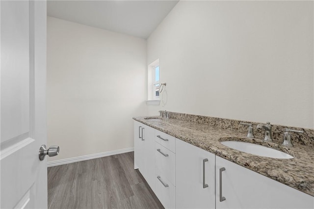 bathroom featuring hardwood / wood-style flooring and vanity