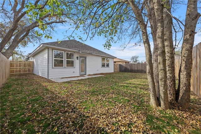 rear view of house with a lawn