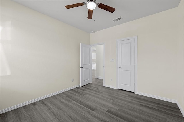 unfurnished bedroom with ceiling fan and dark hardwood / wood-style flooring