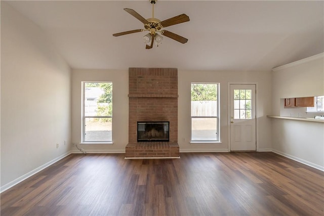 unfurnished living room with plenty of natural light and dark wood-type flooring