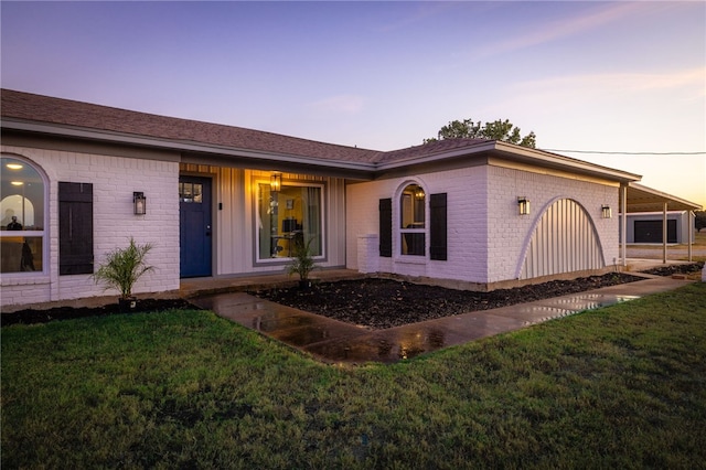 single story home featuring a yard and a carport